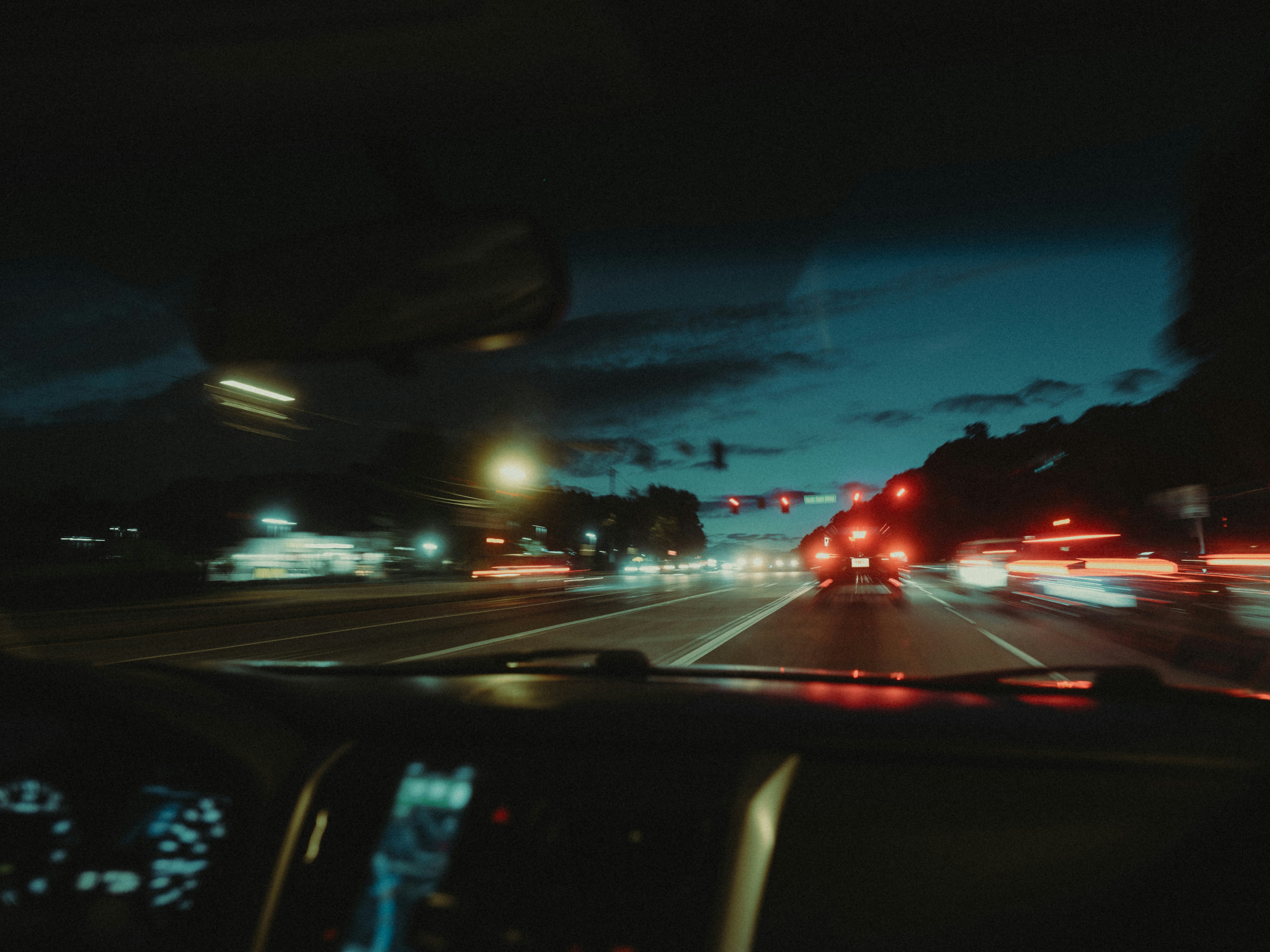 A dark, PSA-style infographic set inside a car interior illustration. The rearview mirror shows a bar chart of crash counts by sobriety, the dashboard gauges show polar clock charts of crash timing, and a roadside billboard shows estimated deaths by gender and sobriety.