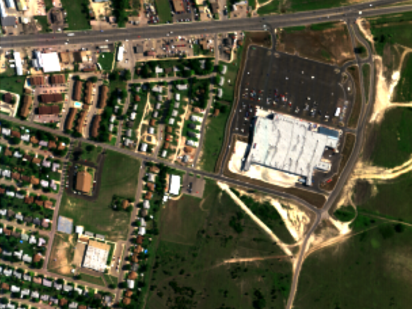 False-color composite of the HYDICE Urban hyperspectral scene showing roads, grass, and rooftops in distinct spectral colors